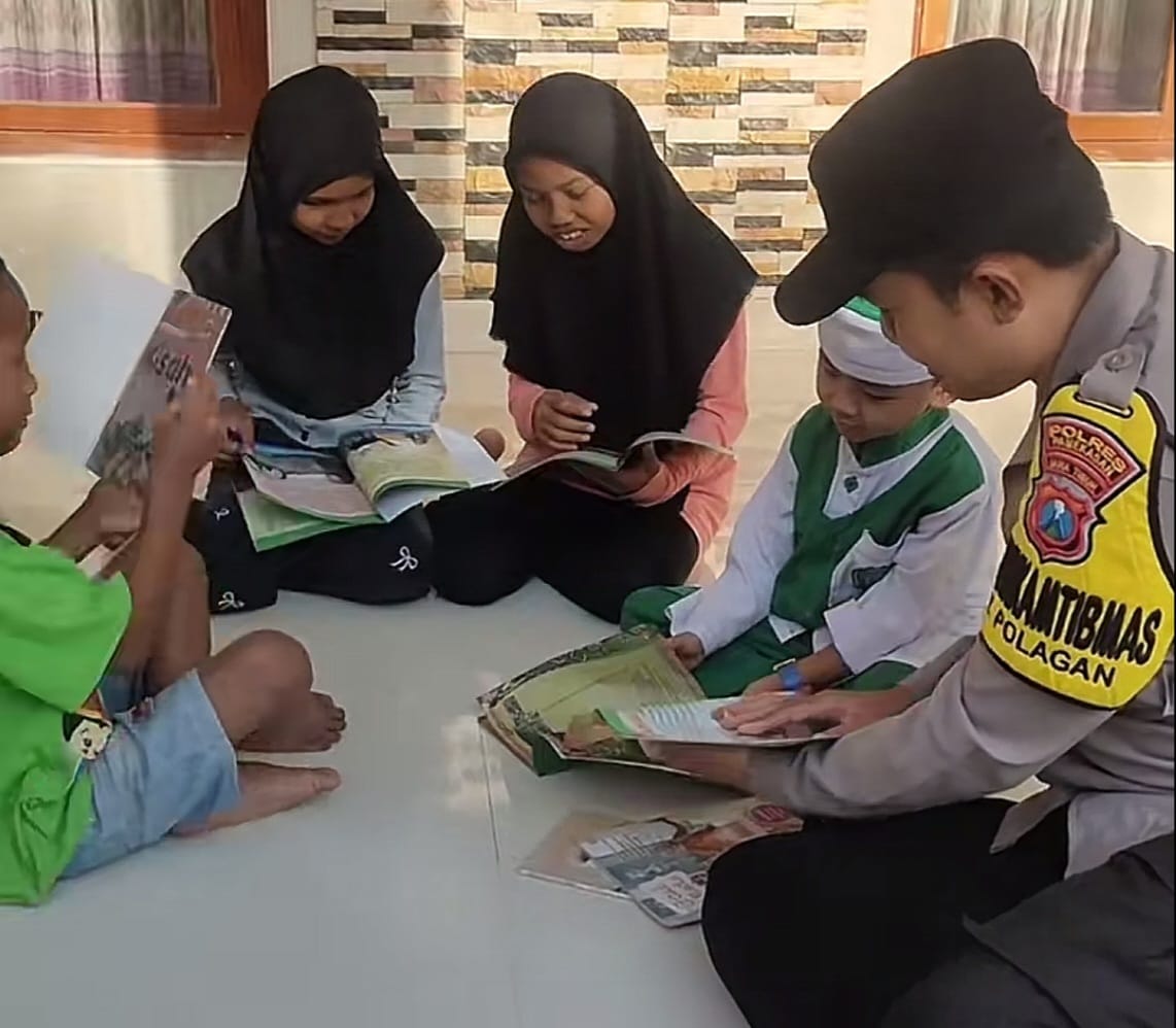 SEMANGAT: Anggota Polri tampak aktif menguatkan literasi siswa melalui kegiatan edukatif yang interaktif dan inspiratif.(Kabar Madura/Ist)